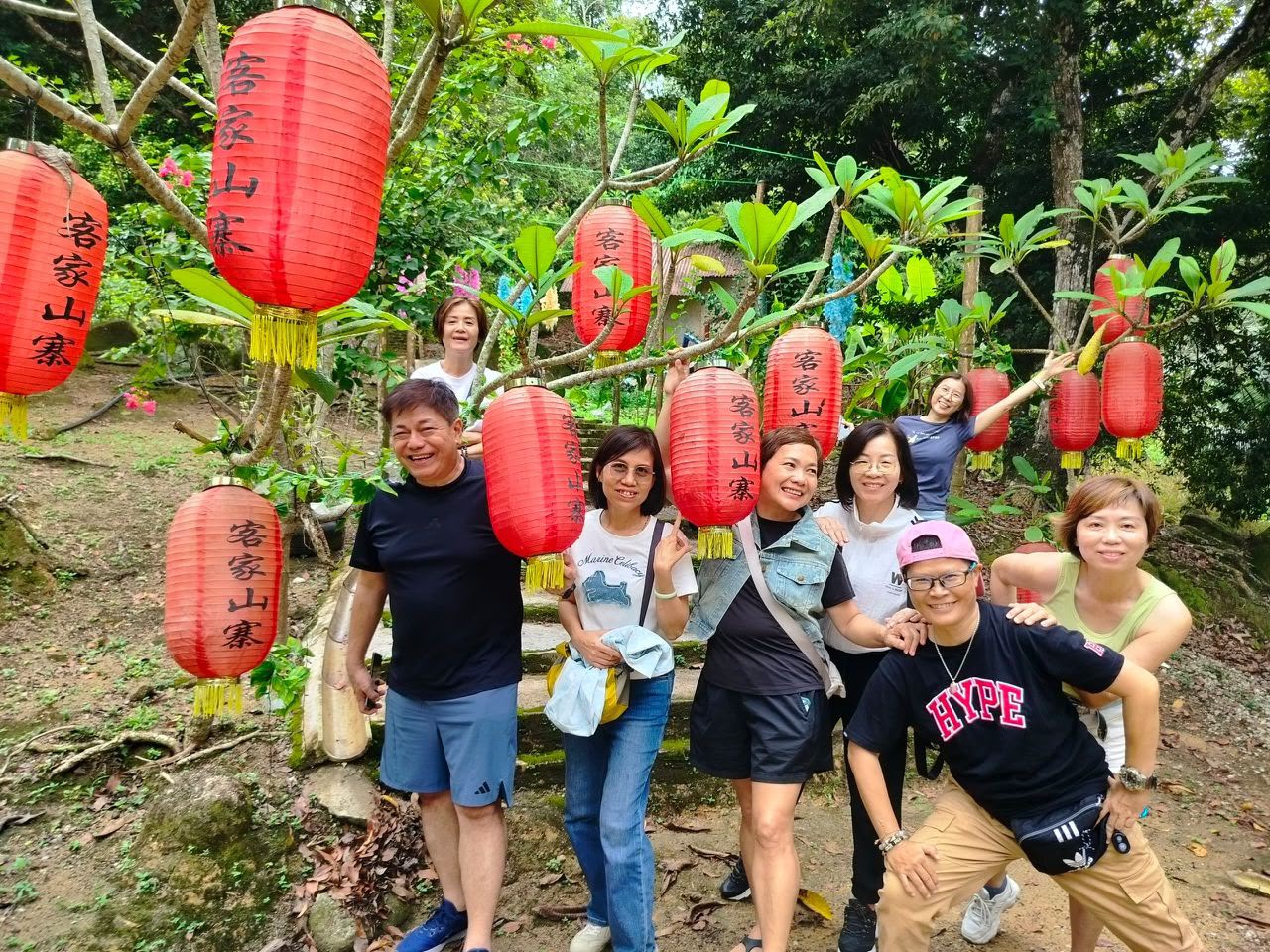 Friends beneath red lanterns in the forest
